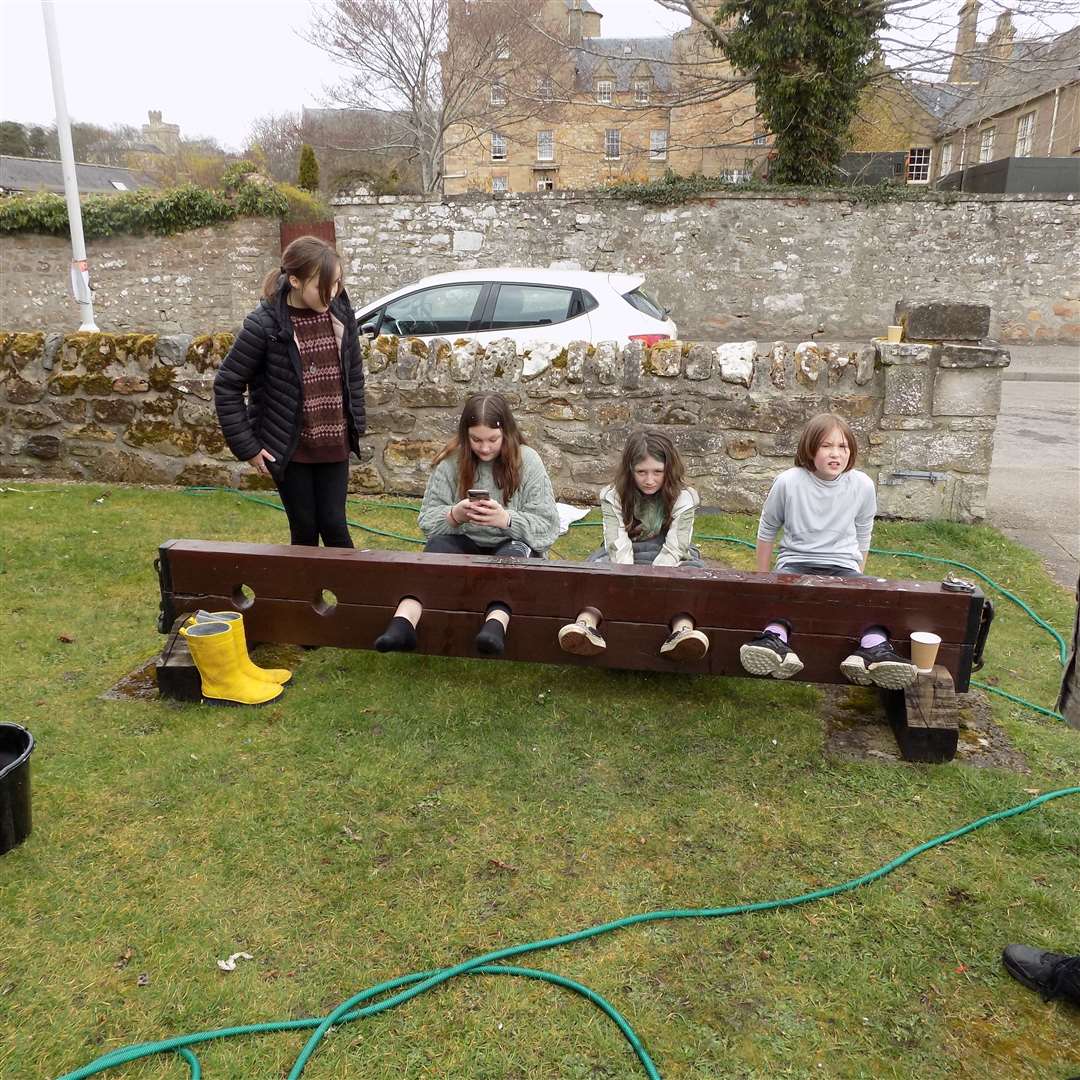 In the stocks are, from left, Ruby Kay Mackay, Jessica Foy, Mary Jane Currie and Isla Swanson.