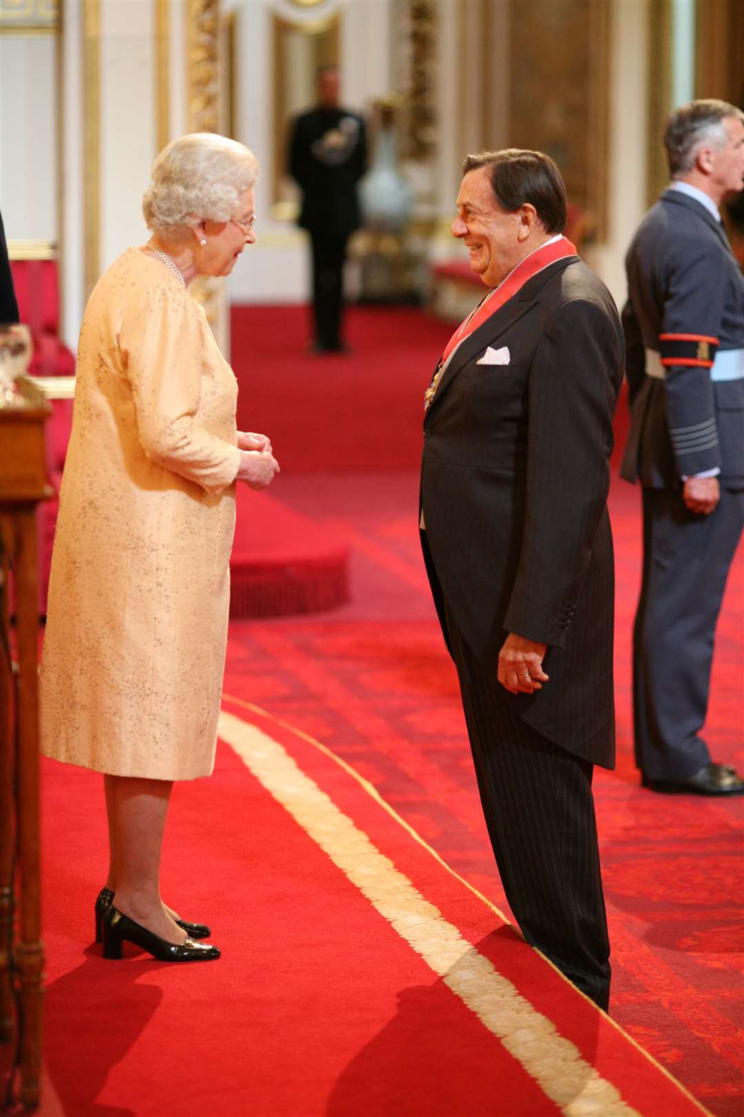 Humphries being made a Commander of the British Empire by Queen Elizabeth II at Buckingham Palace in 2007, for services to entertainment (PA)