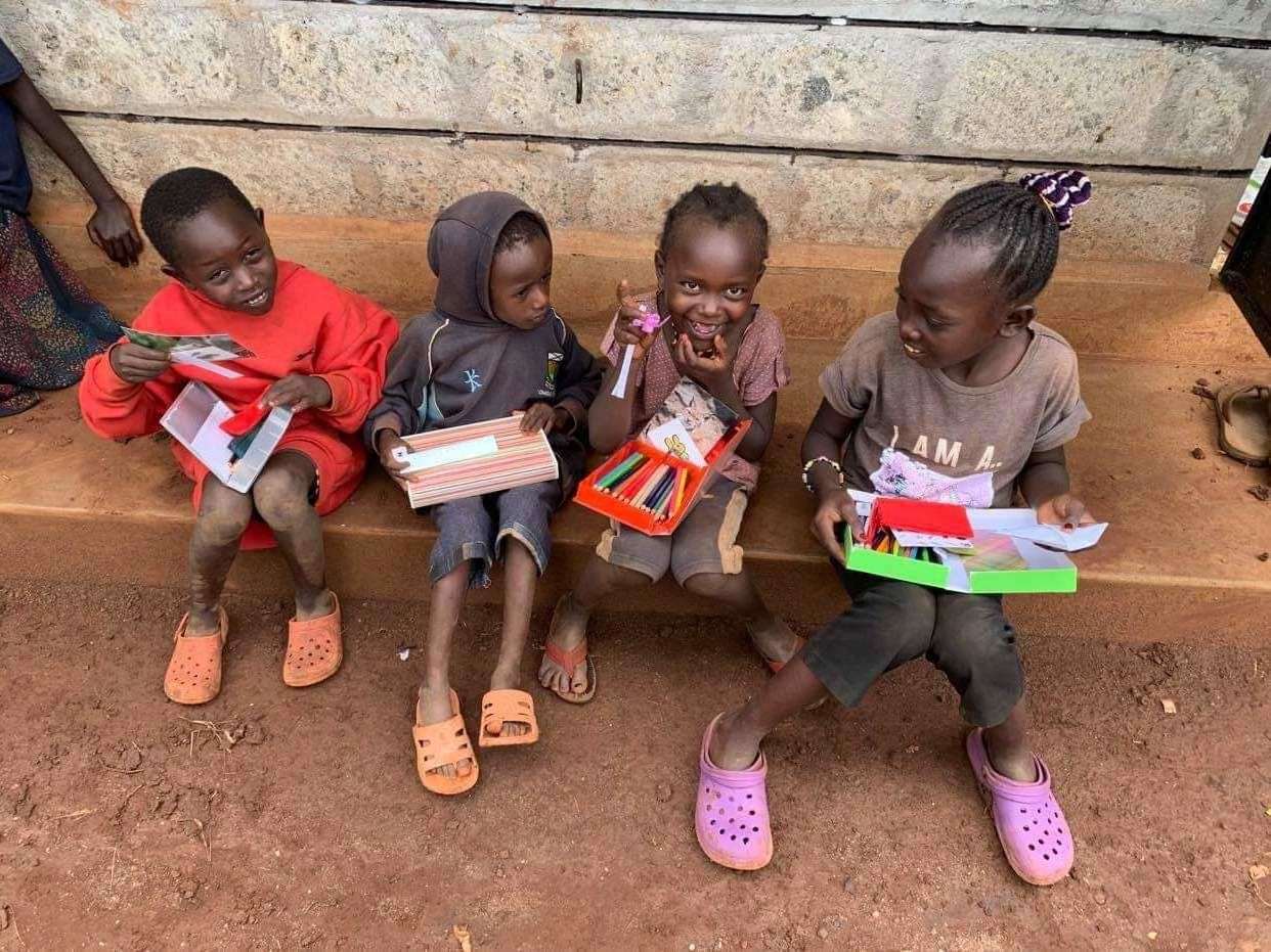 The joy on the faces of these four young children is clear as they check out the study cases, sent out from Brora after being stuffed full of stationery.