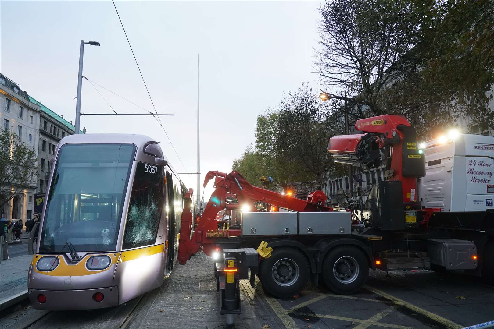 A damaged Luas with broken windows is removed from the tracks in Dublin, the morning after violent scenes unfolded in the city centre (Brian Lawless/PA)