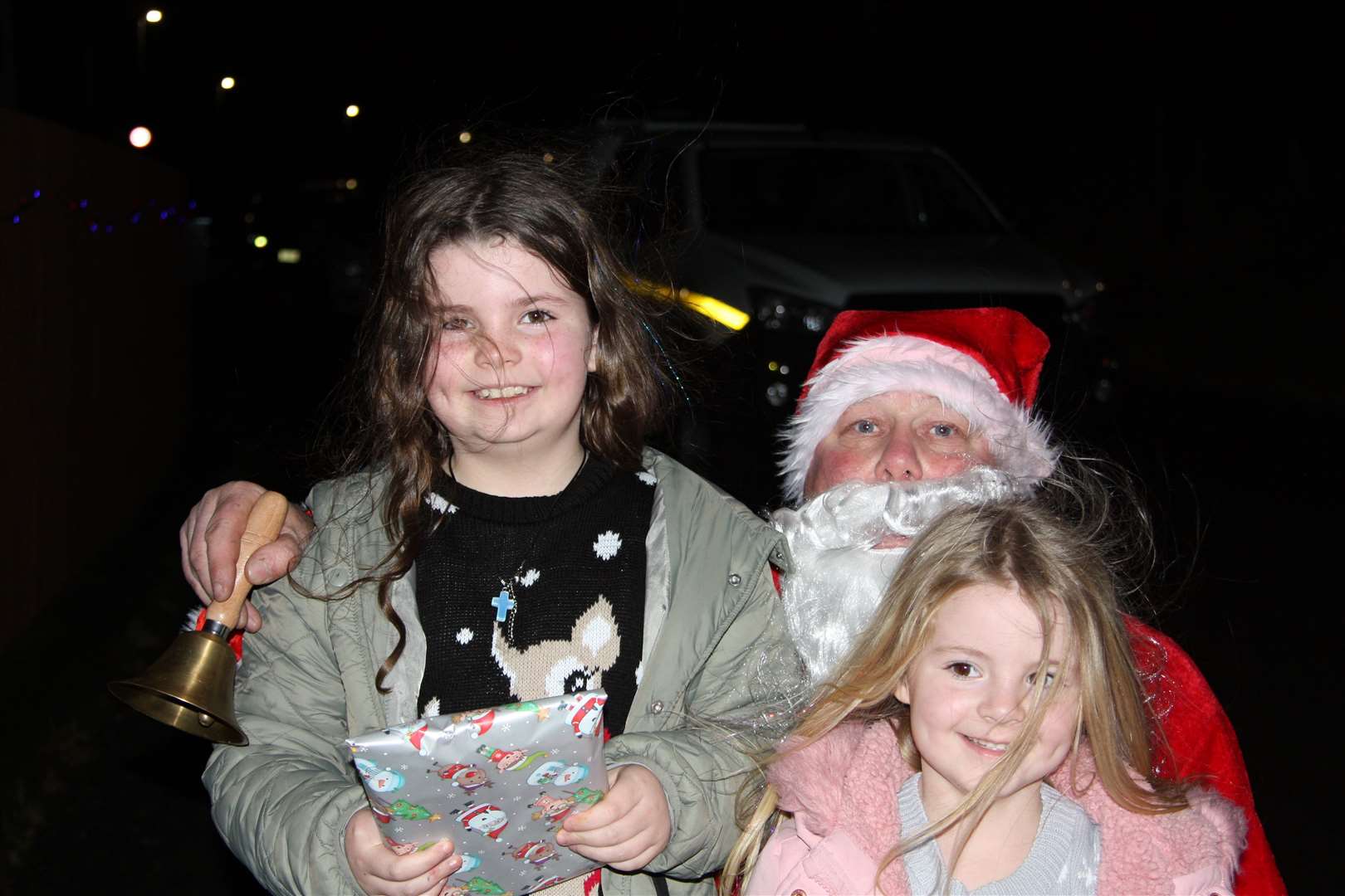 Big smiles from Massie and Jesy Custerson as Santa arrives bearing gifts.