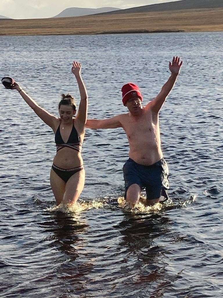 Patrick and Alice celebrate completing a chilly November swim in Loch Achnamoine, near Loch Badanloch, by Kildonan.