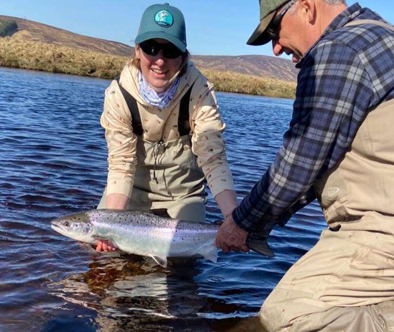 Yvonne Grant lands her first spring salmon on the River Helmsdale last year, helped by her dad Andy Sutherland.