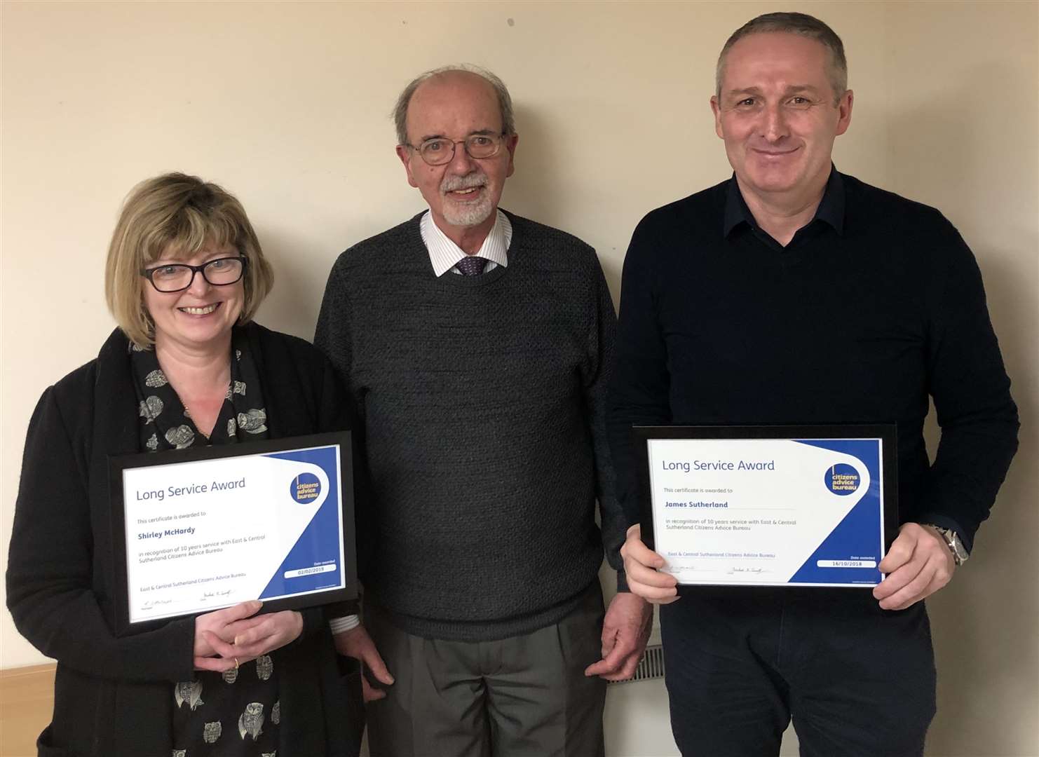 Shirley McHardy and James Sutherland were presented with their long service awards by Michael Small (centre).