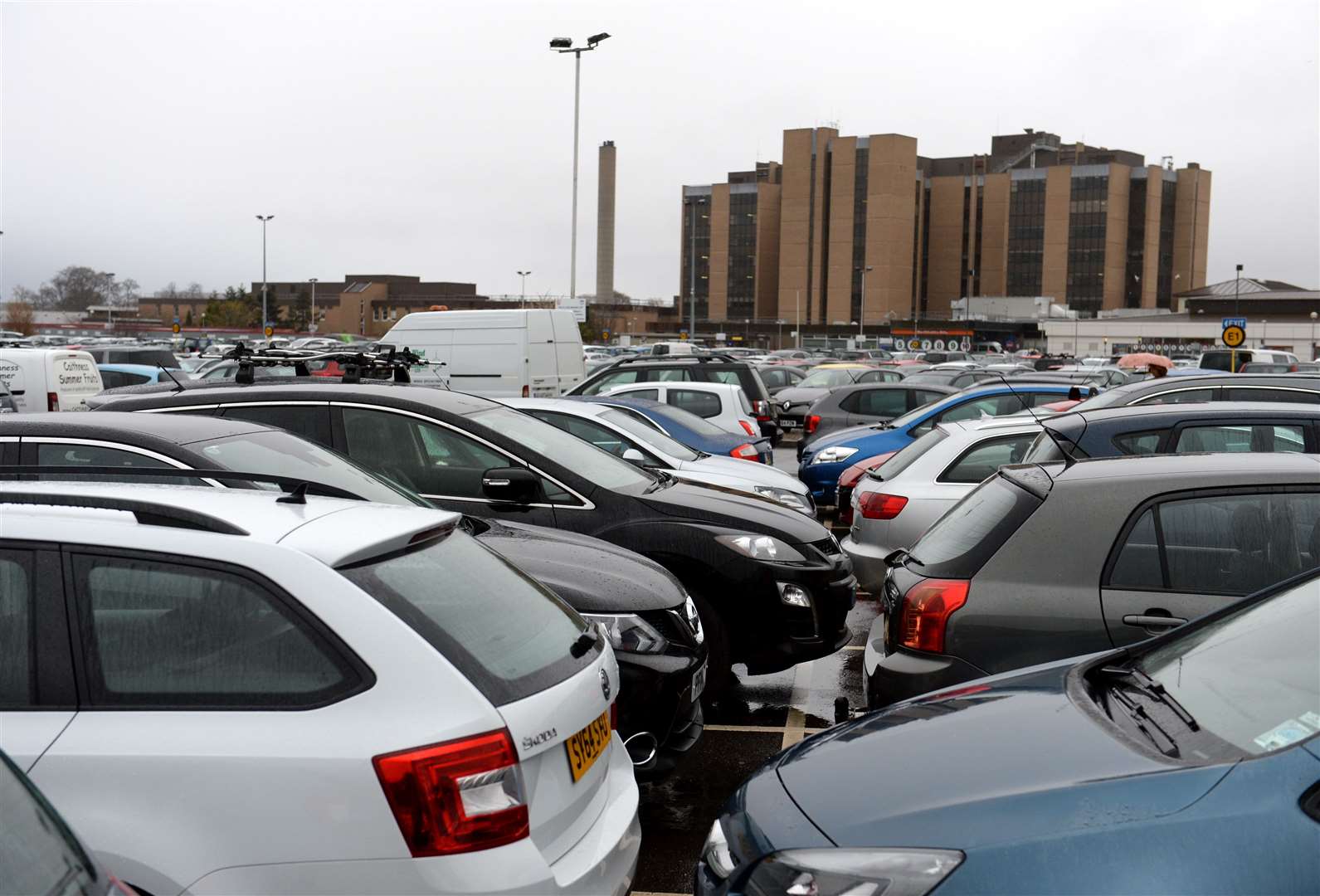Sea of vehicles parked in various positions and places at Raigmore Hospital car park.