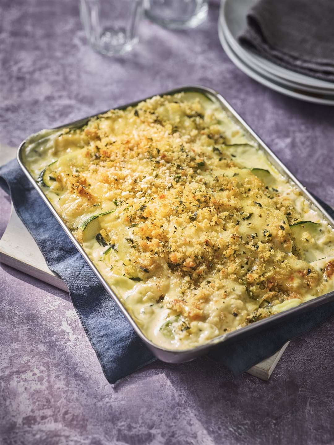 Baked courgettes with cream and Comté breadcrumbs.