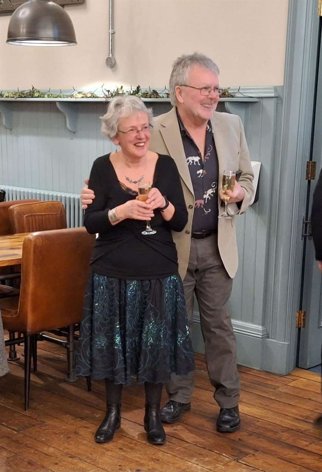 Joan and her husband Jerry arrive at the surprise party.