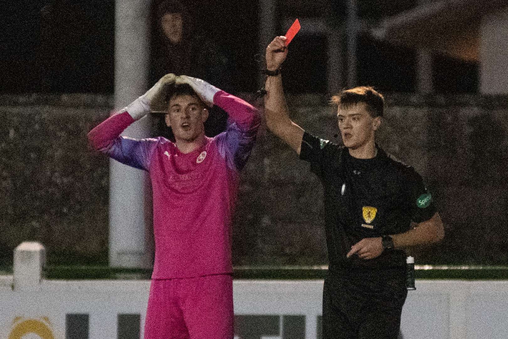 Referee Joel Kennedy erroneously gives Brora goalkeeper Lenny Wilson his marching orders. Picture: Daniel Forsyth