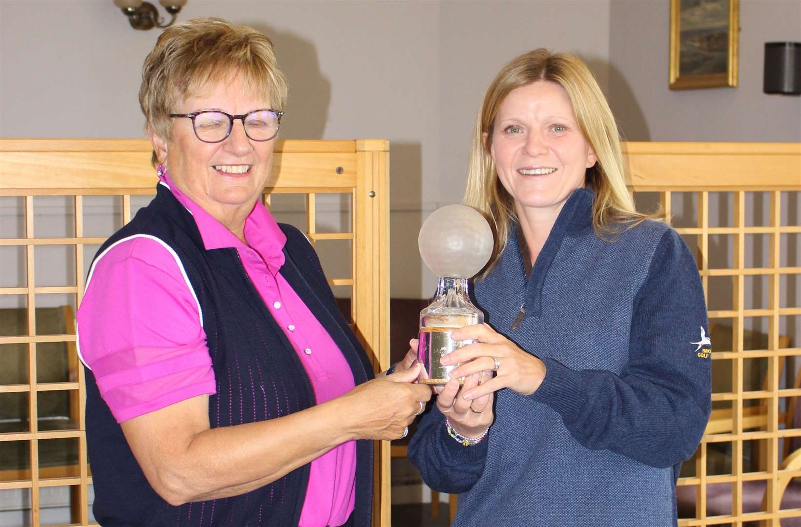 Anne Sutherland (Royal Dornoch) receives her Links Apartments Trophy from Brora captain Anne Clarke.