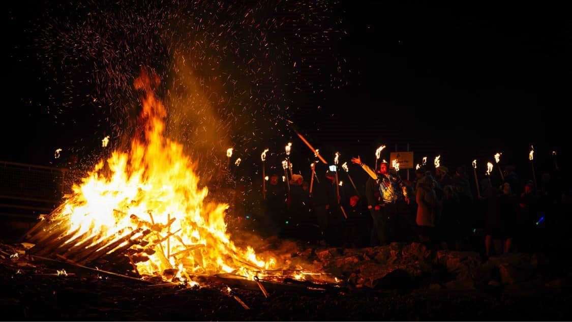 The torches were thrown onto the bonfire. Picture: Martin Ross