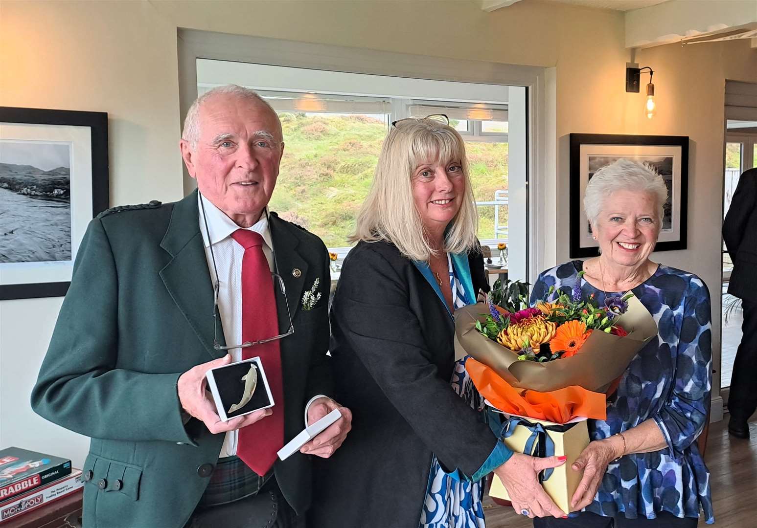 David Grant shows off the specially commissioned silver kilt pin he received on standing down as a deputy lord lieutenant while Vice Lord-Lieutenant Kim Tulloch presents his wife Norah with a bouquet of flowers.