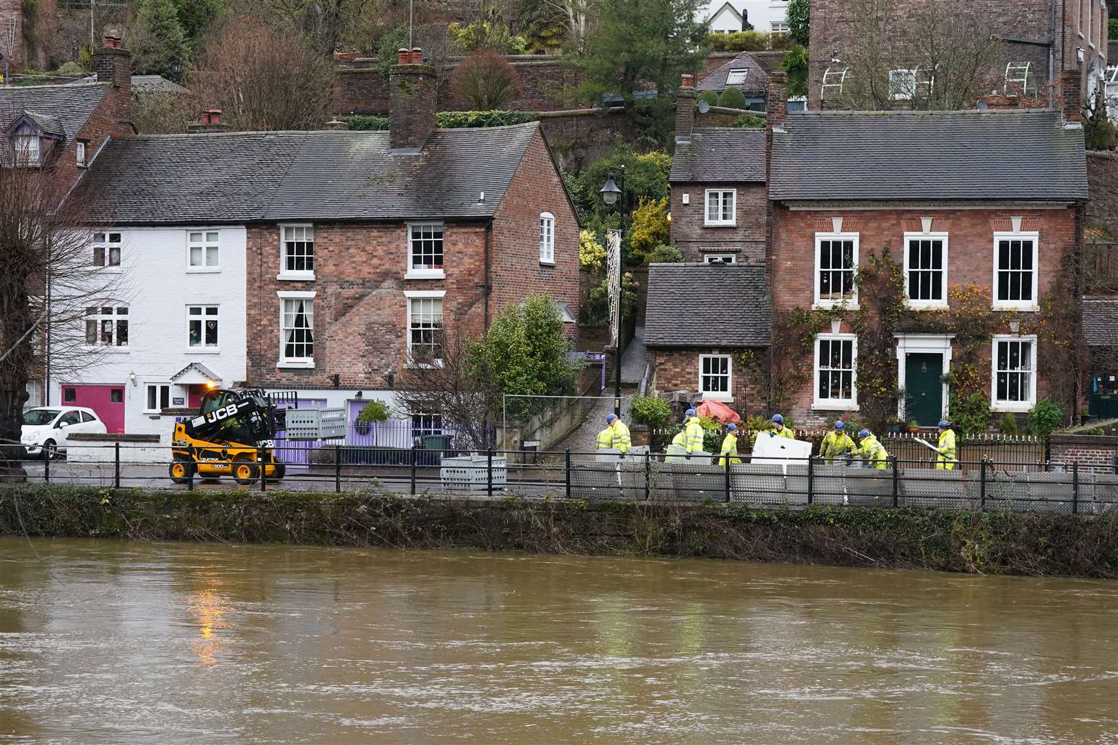 Flood defences were put up along the swollen River Severn at Ironbridge in Telford, Shropshire (Nick Potts/PA)