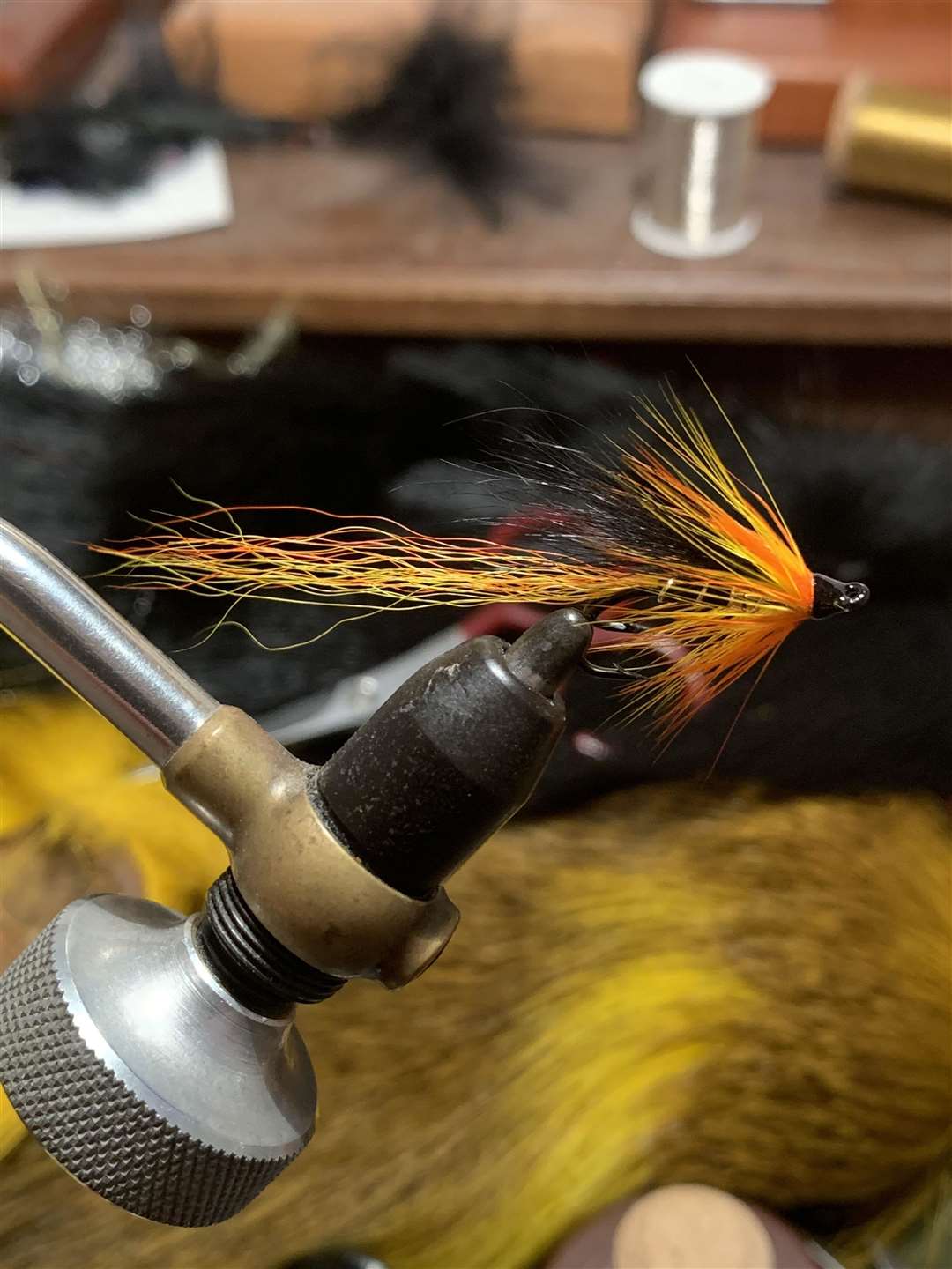 A Cascade salmon fly which has just had varnish applied.