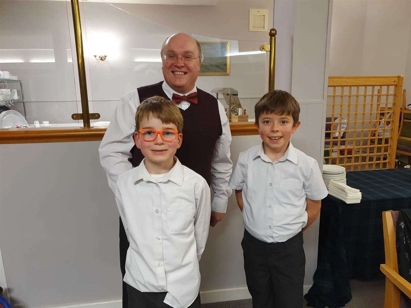 Rotarian Simon Scott was ably assisted as bingo caller at the St Andrew’s night fundraiser by these two young lads.
