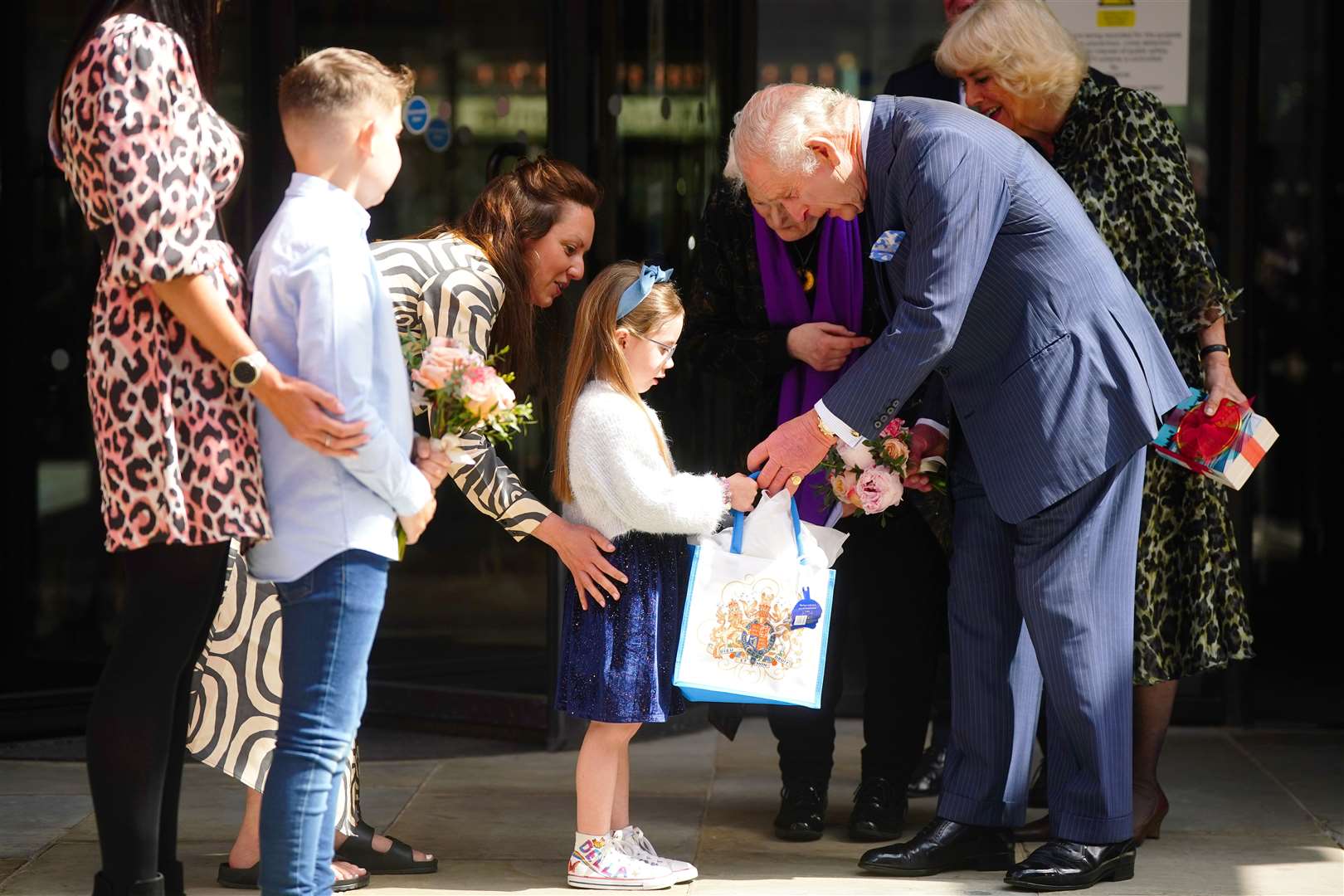 The King is presented with a bouquet following a visit to University College Hospital Macmillan Cancer Centre (Victoria Jones/PA)