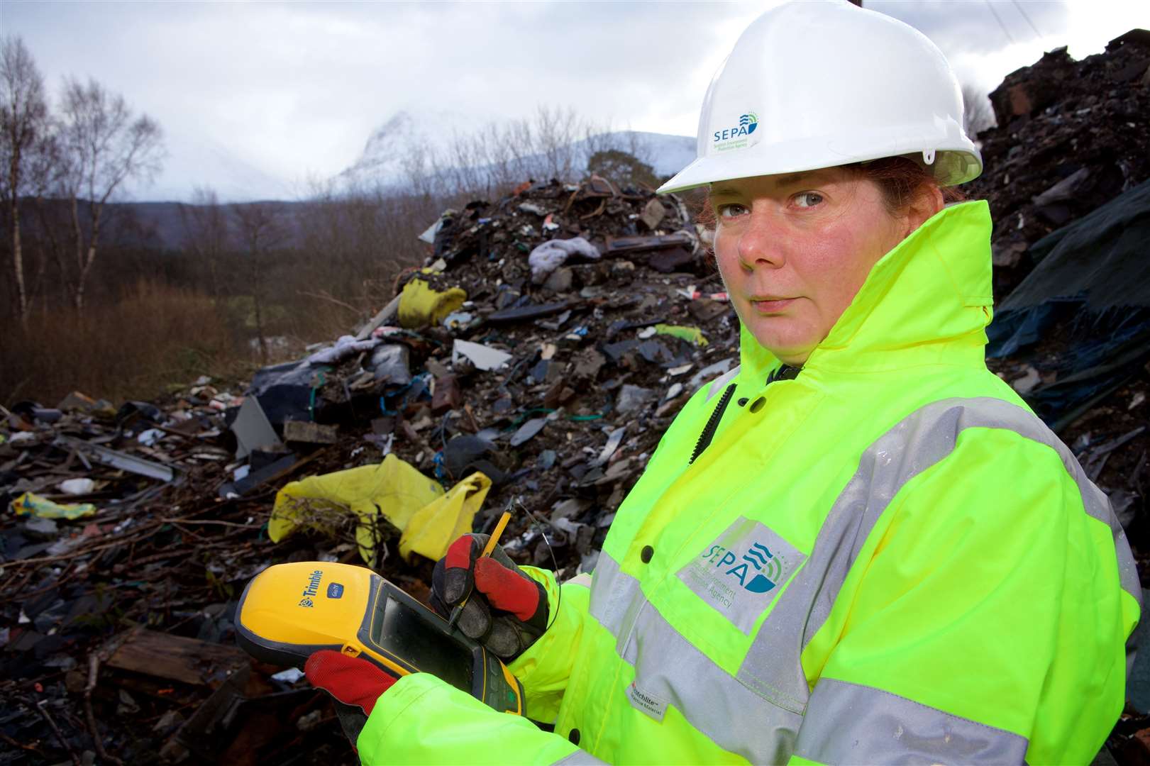 A SEPA officer at a fly-tipping site in Fort William.