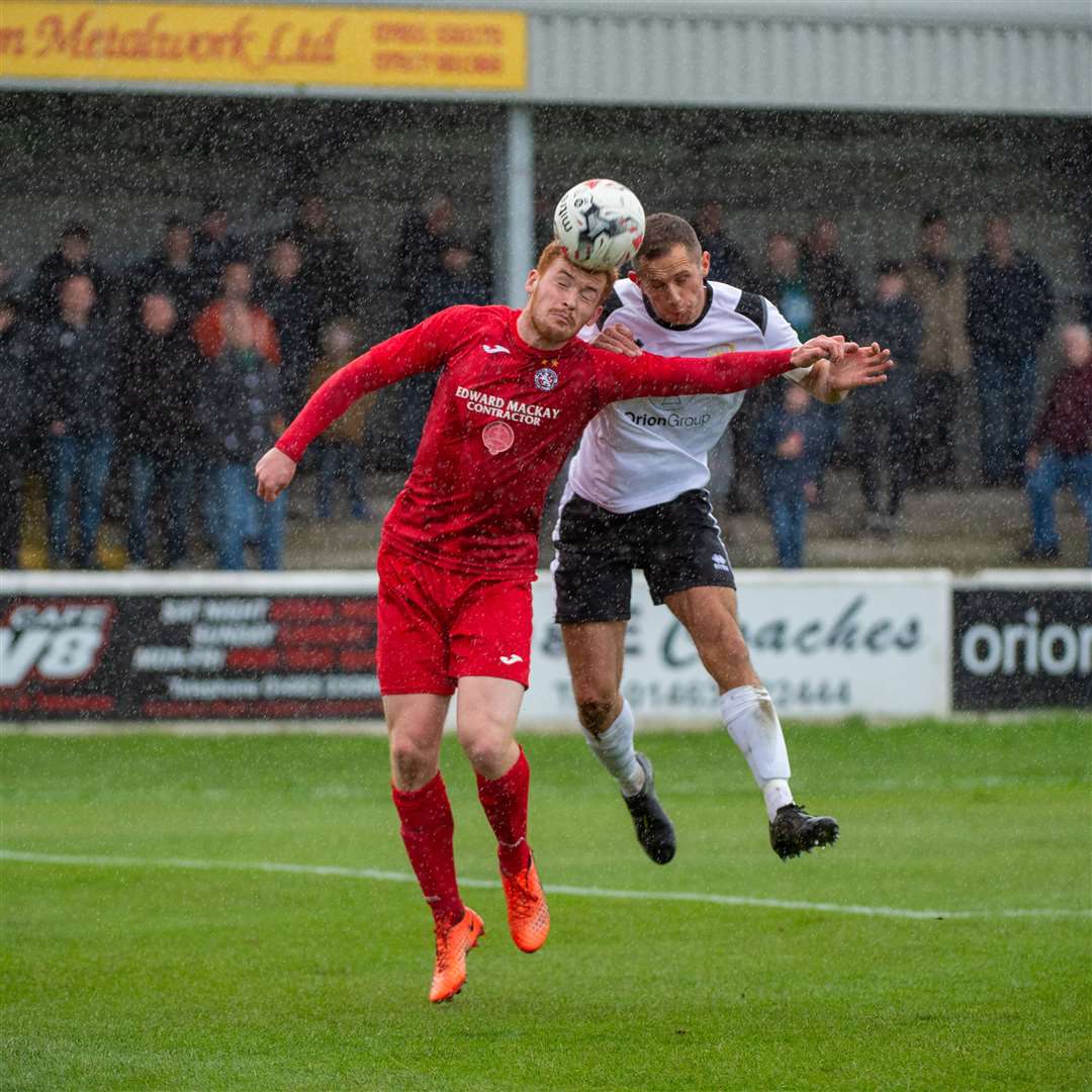 Brora's Greg Morrison and Clach's Michael Finnis challenge for the ball.