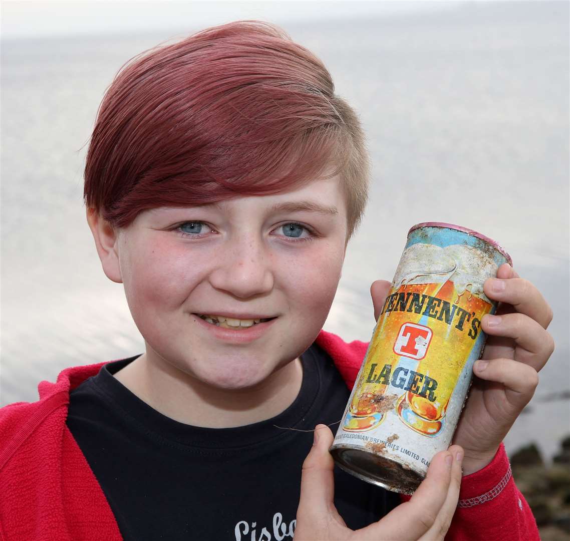 Jack Emery (11) with the Tennent's lager can from 1975 that he found whilst walking along the shore of the Cromarty Firth with his mum Fiona. Picture: Peter Jolly