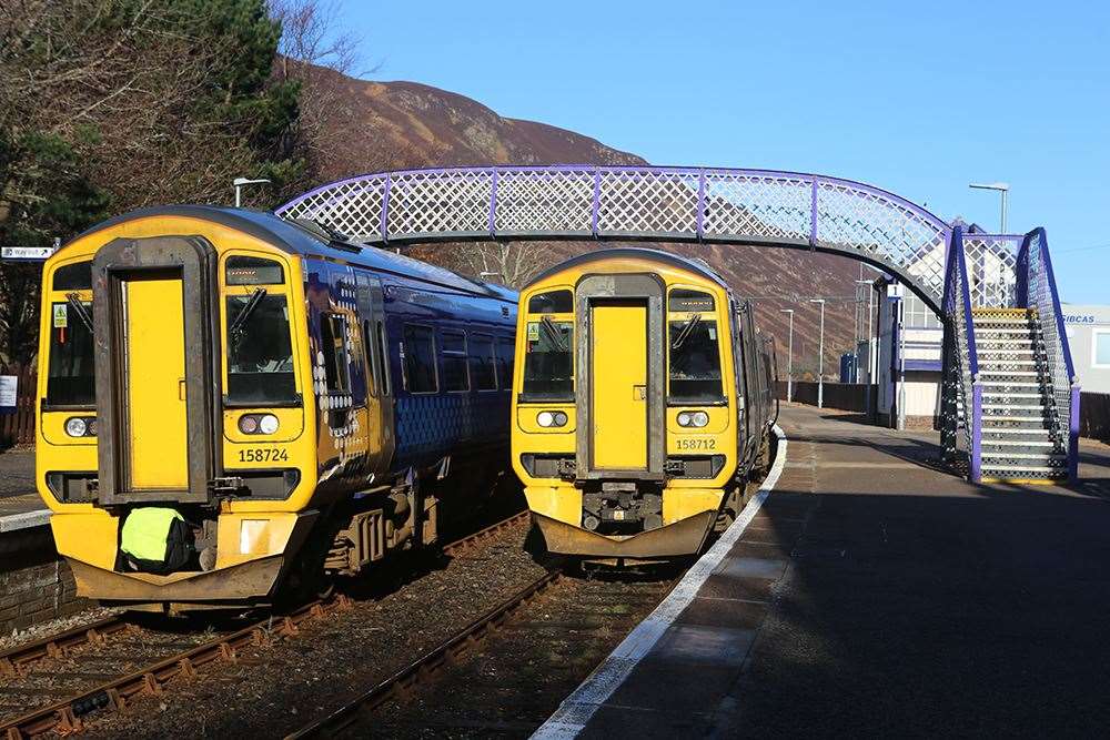 Trains passing at Helmsdale Station.