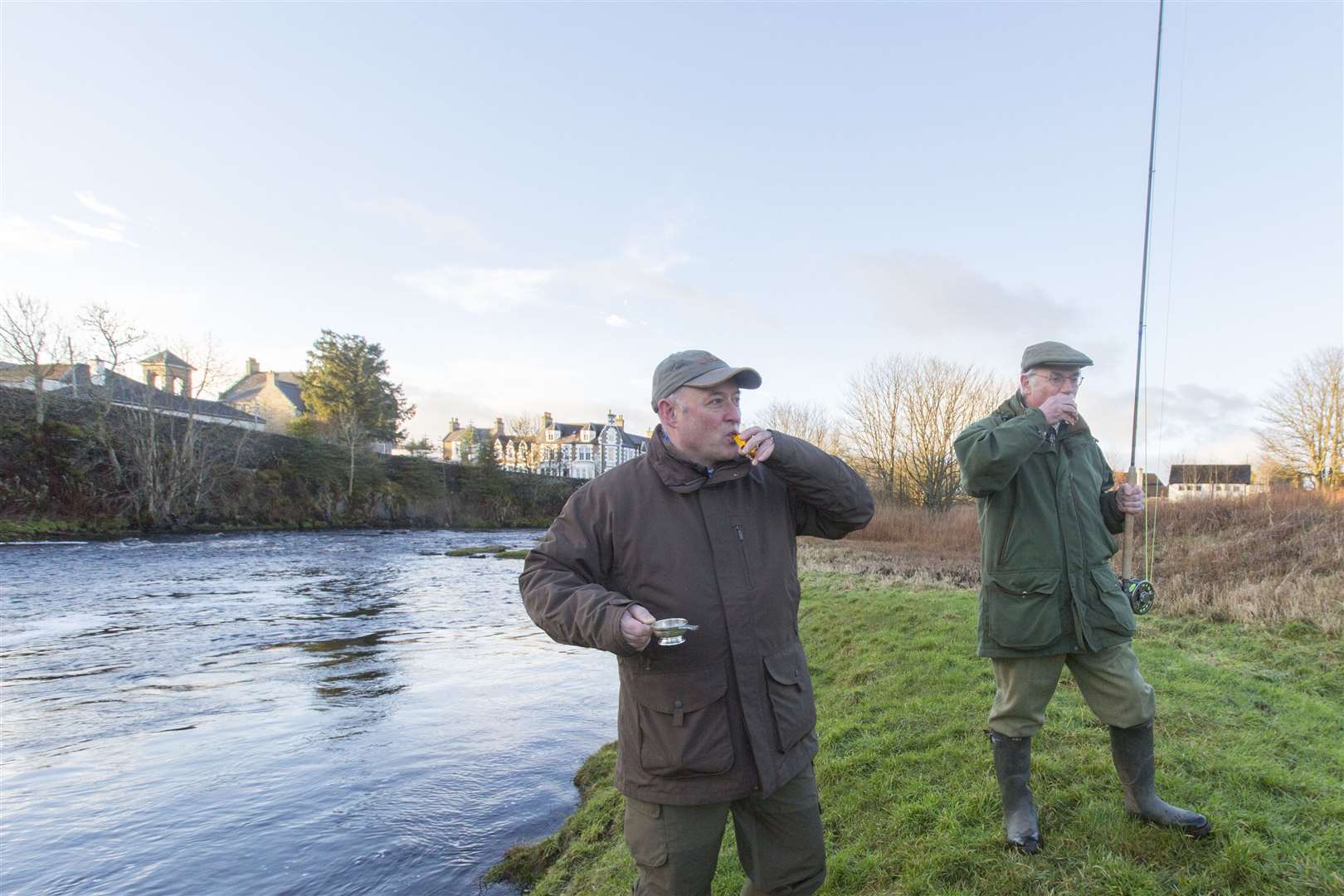 John Drummond (left), estate manager for Thurso River Ltd, proposes a toast to the salmon season on the river along with Francis Sandison, who cast the first fly. Picture: Robert MacDonald / Northern Studios