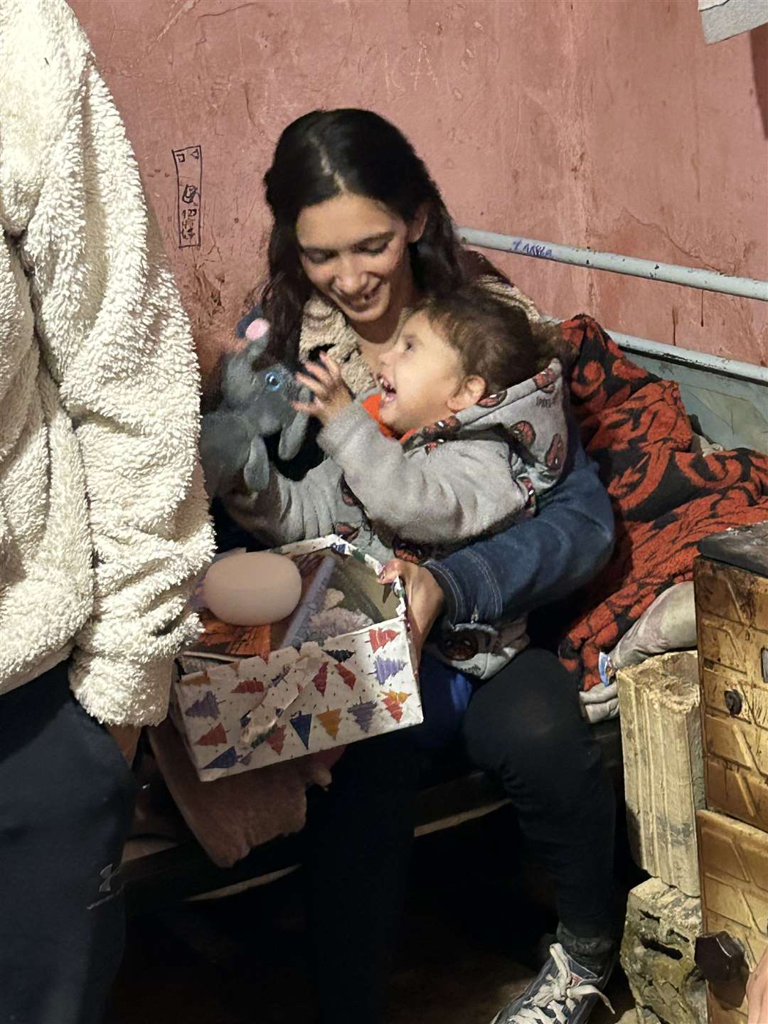 Sliven, Bulgaria, 9 December 2023: a child in a Roma community shows his delight atfinding a toy in his Blythswood shoebox