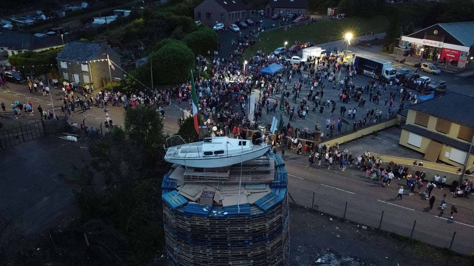 People watch as the pyre with a boat on top is lit (Niall Carson/P)A