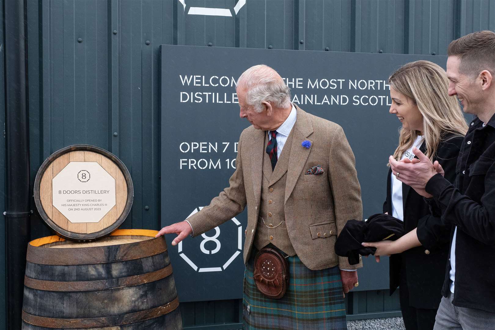 The King unveiling the plaque at 8 Doors Distillery this summer, with owners Kerry and Derek Campbell looking on. Picture: Susie Mackenzie