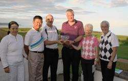 David Paterson (third left) presents the Adamson Trophy to David and Morag Carter. On the left are Mandy and Peter Lee (Royal Dornoch) and on the right Marlene Bokas (Brora lady captain).