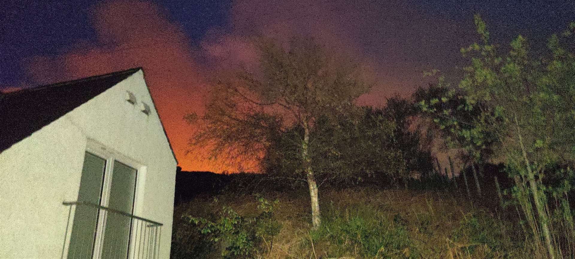 Flames light the night sky near Kyle.