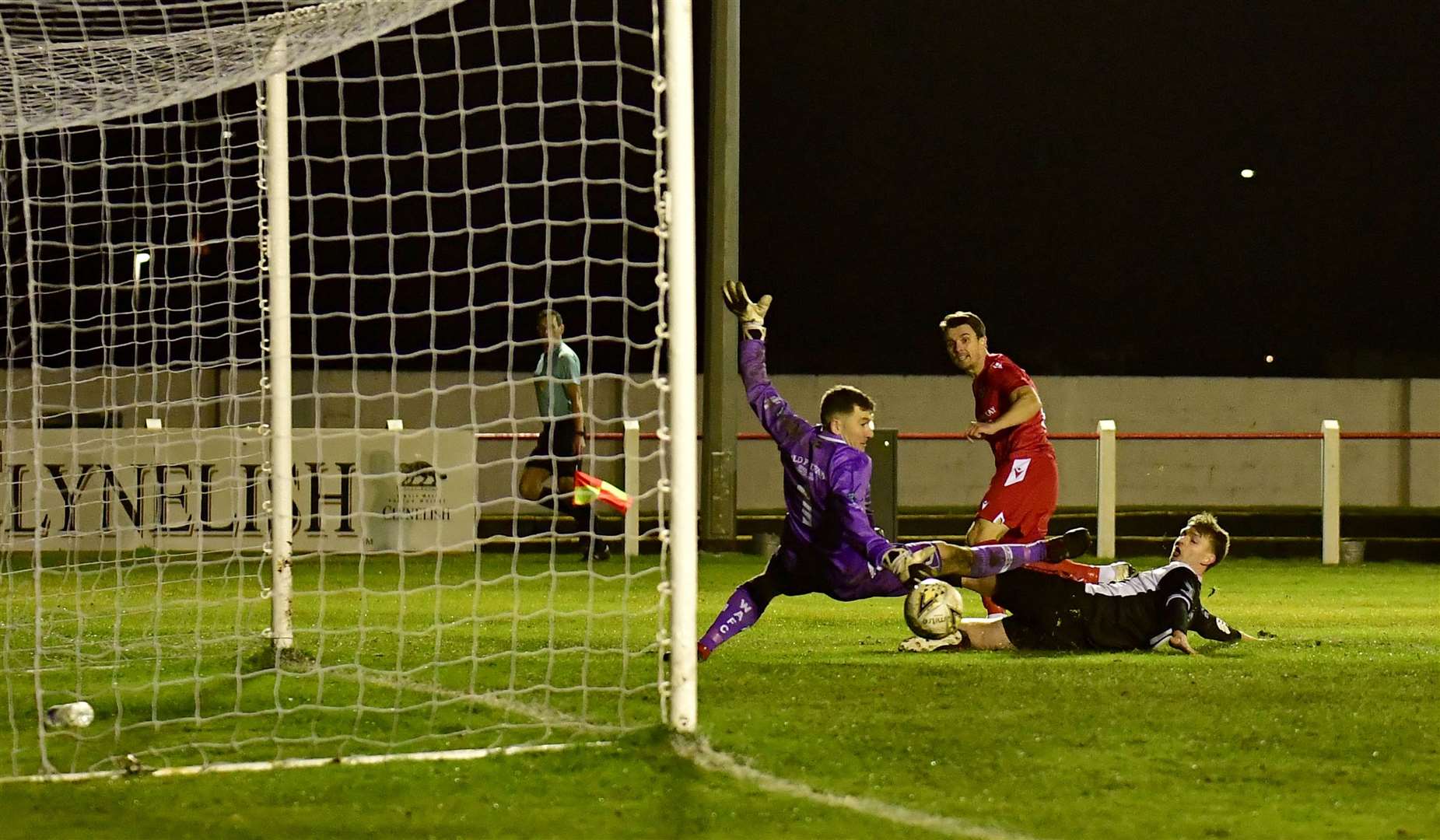 One last goal for Steven Mackay as he slots the ball past Wick Academy's Andrew Hardwick and keeper Graeme Williamson before announcing his decision to retire as a player. Picture: Mel Roger