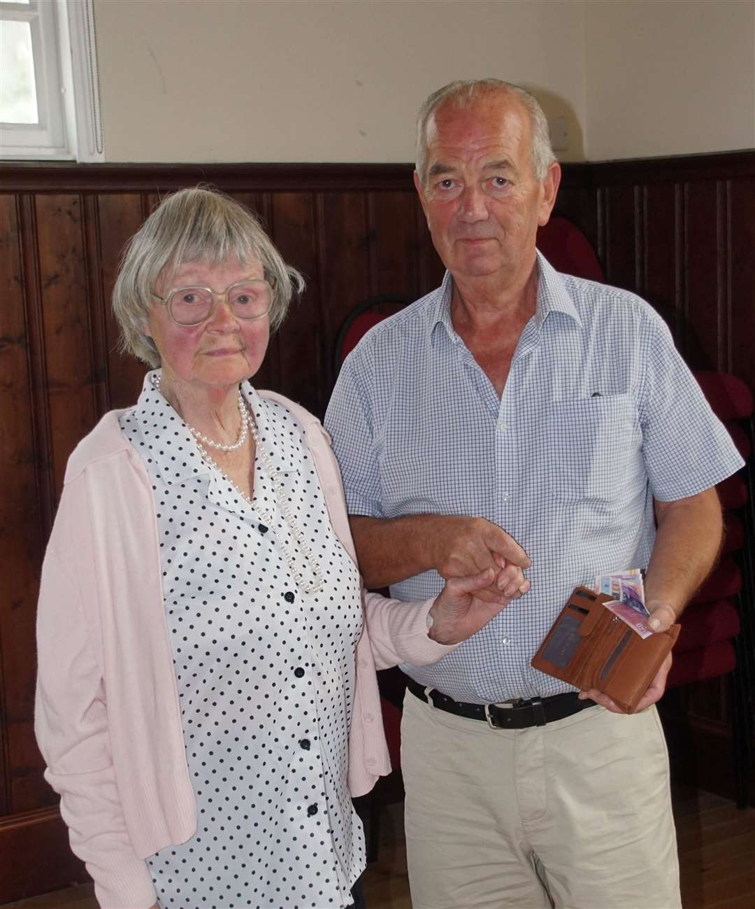 James Horne receives his wallet and donation from Barbara Campbell, who has been going to the post office since James took it over.