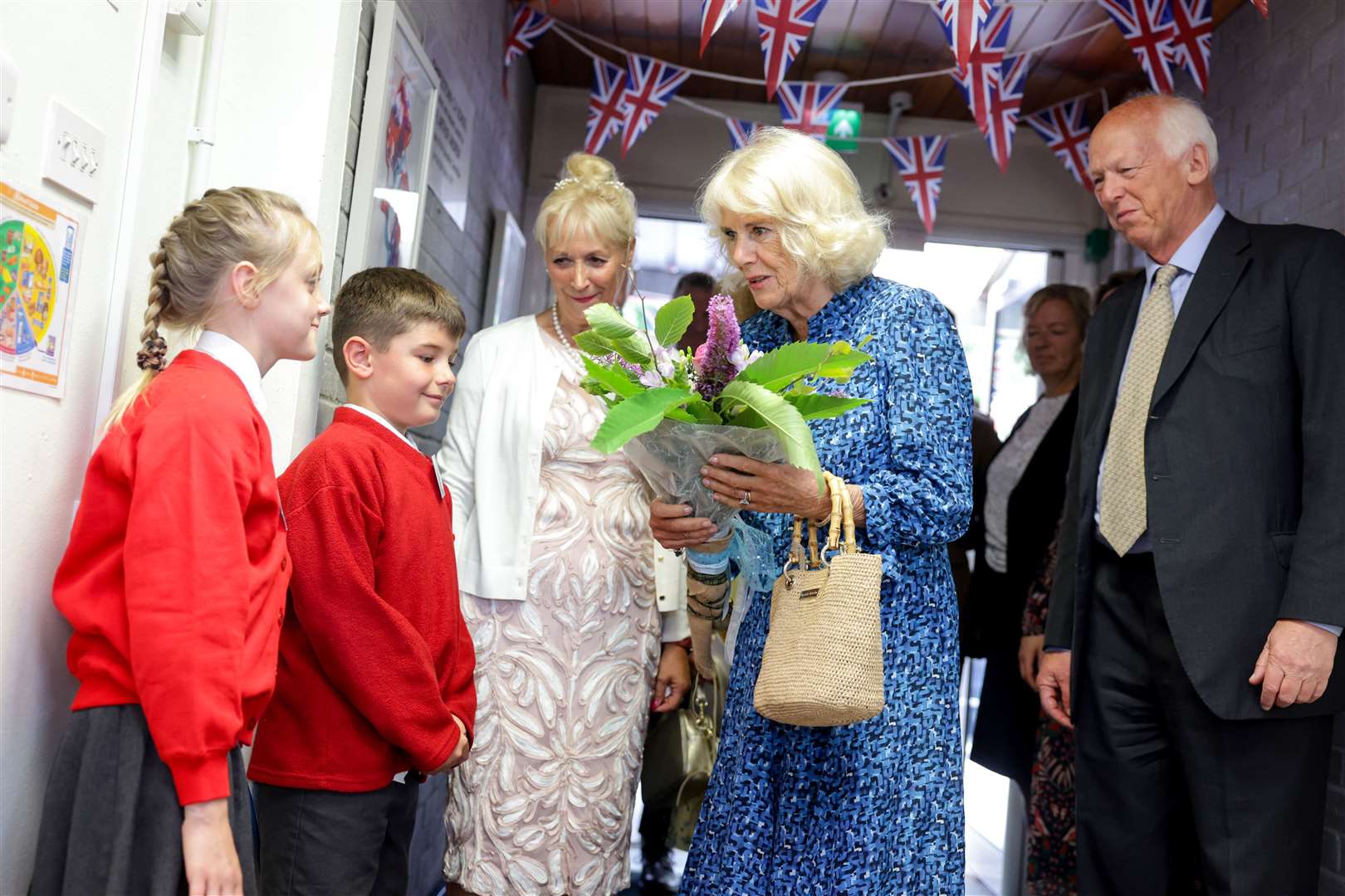 The Duchess of Cornwall receives a bunch of flowers from pupils at Charlestown School in St Austell (Chris Jackson/PA)