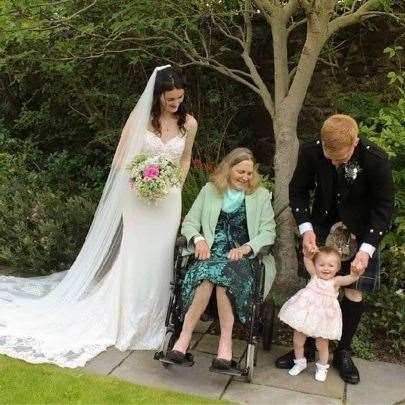Kim and her husband Stuart on their wedding day, with their daughter Bella, Deirdre and Izzi all present.