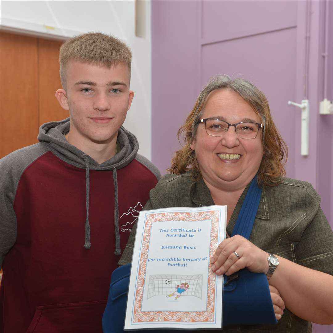 Maths and science specialist Snezana Basic was presented with her bravery award by footballer Lewis Mackay. Picture: Jim A Johnston