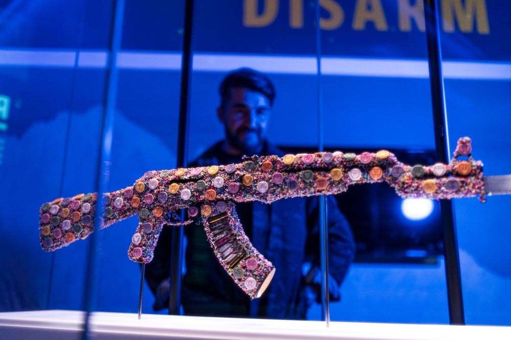 The exhibition also includes artworks by veteran-turned-artist Bran Symondson-Baxter, which includes two AK-47s decorated with Love Heart sweets (Royal Armouries/PA)