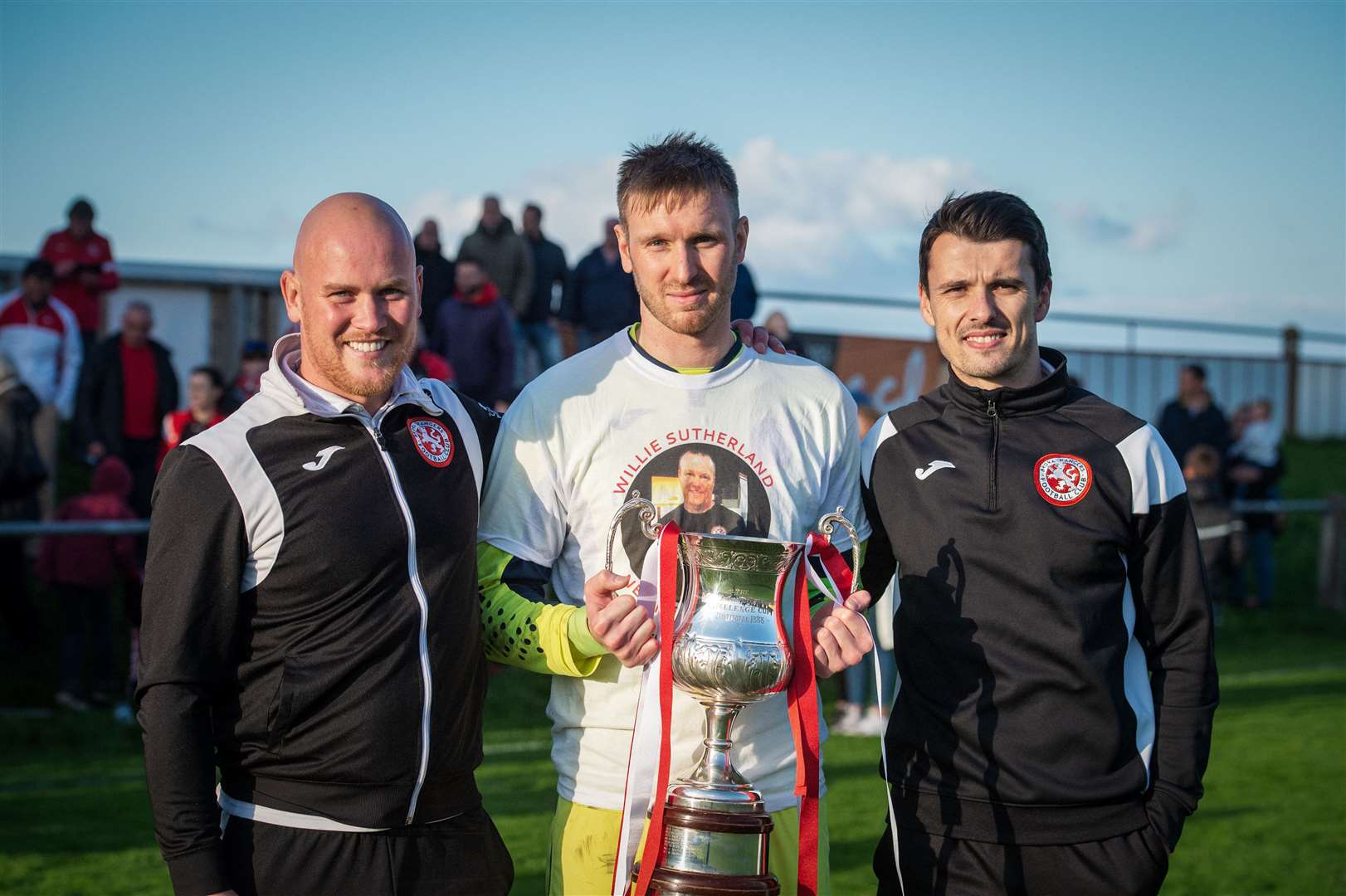 Assistant manager Craig Campbell (left) and manager Steven Mackay (right) with goalkeeper Joe Malin after winning the North of Scotland Cup in 2019. Picture: Callum Mackay