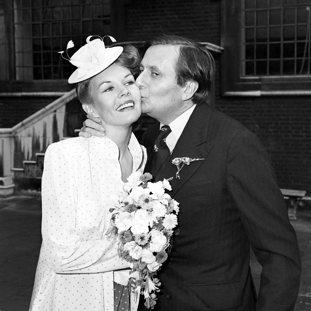 Dame Edna Everage is nowhere in sight as her creator, 45, kisses his wife, 30-year-old artist Diane Millstead, after their marriage had been blessed at St James’s Church, Piccadilly, in 1979 (PA)