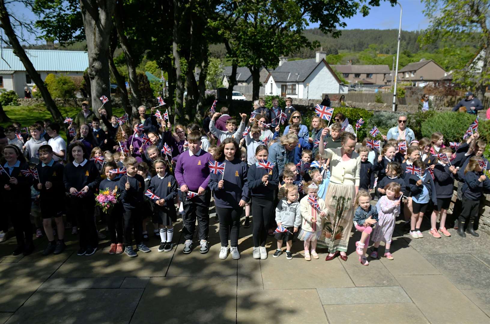 School children waved their Union Jack flags enthusiastically when the royal couple entered Golspie's Memorial Garden. Picture: James MacKenzie