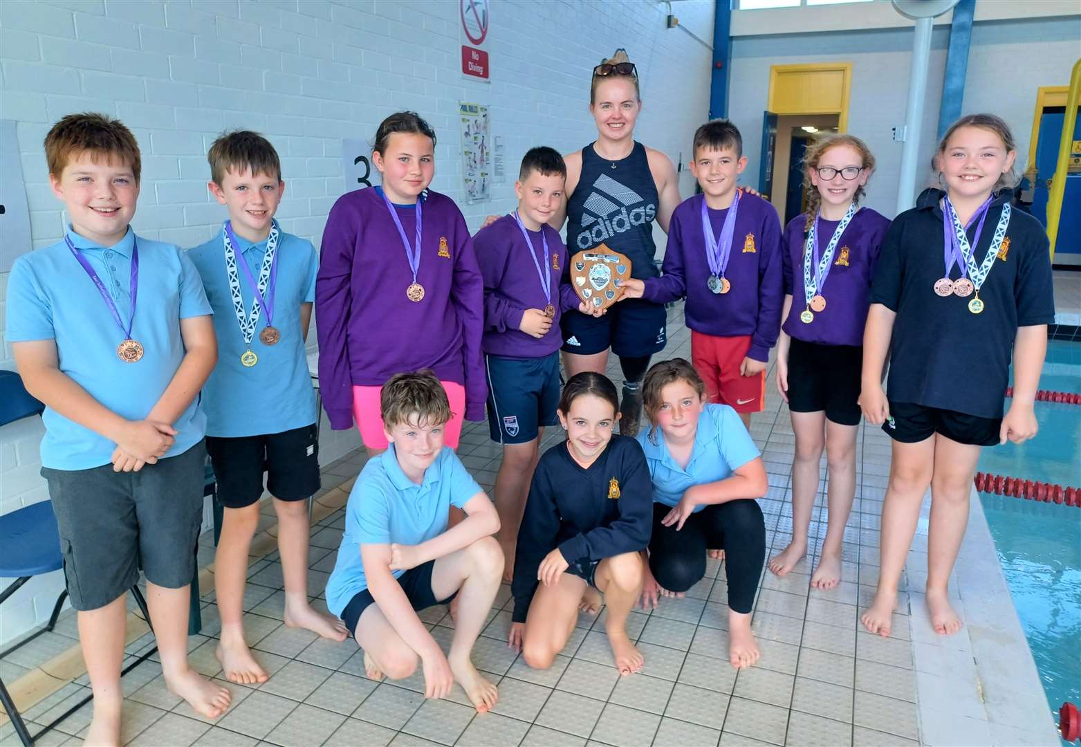 Hope Gordon (above) with the Golspie primary swimming team who won the Big Schools trophy. Back, from left, Harvey McDonald, Leo Lannon, Layla McDonald, Marcus Mackay, Torin Sutherland, Sophie Bonner and Ella Smith. Front: Toby Sutherland, Bonnie Sutherland and Maria Morrison.
