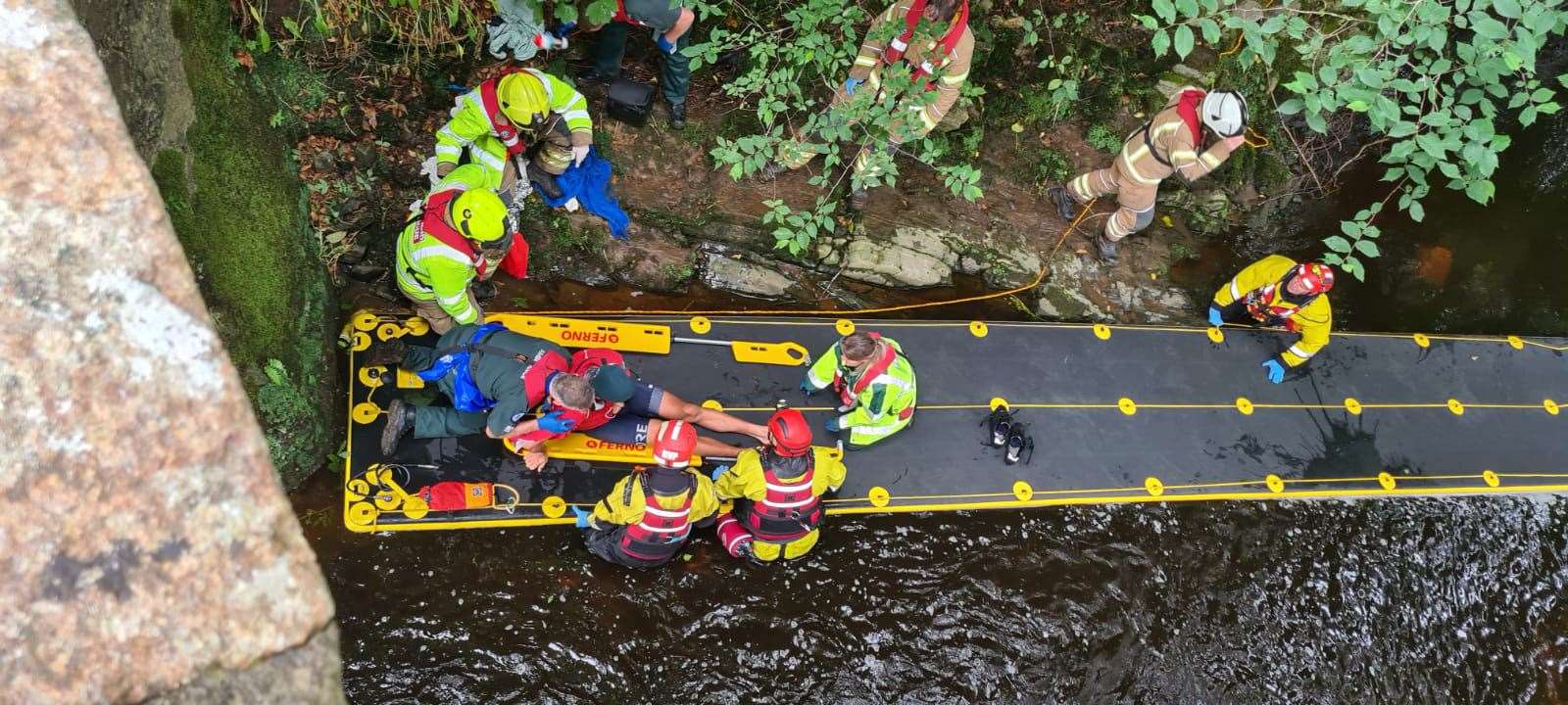 Emergency services rescuers used a large raft to get Duncan Brown to safety. Picture: Jasperimage.