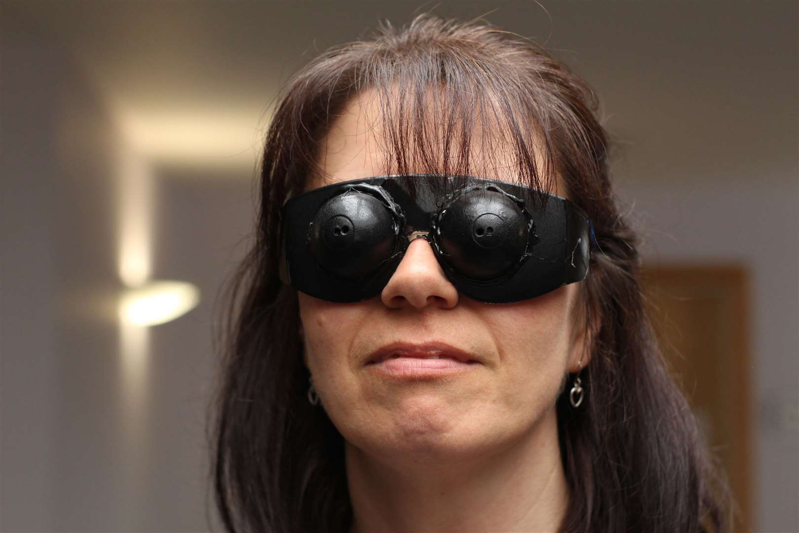 Pauline Gibson, sensory support worker at Hearing and Sight Care, wearing simulation specs showing how a person’s sight is limited by retinitis pigmentosa, leading to tunnel vision. This was at a Caithness Health and Wellbeing Market in Wick in 2019.