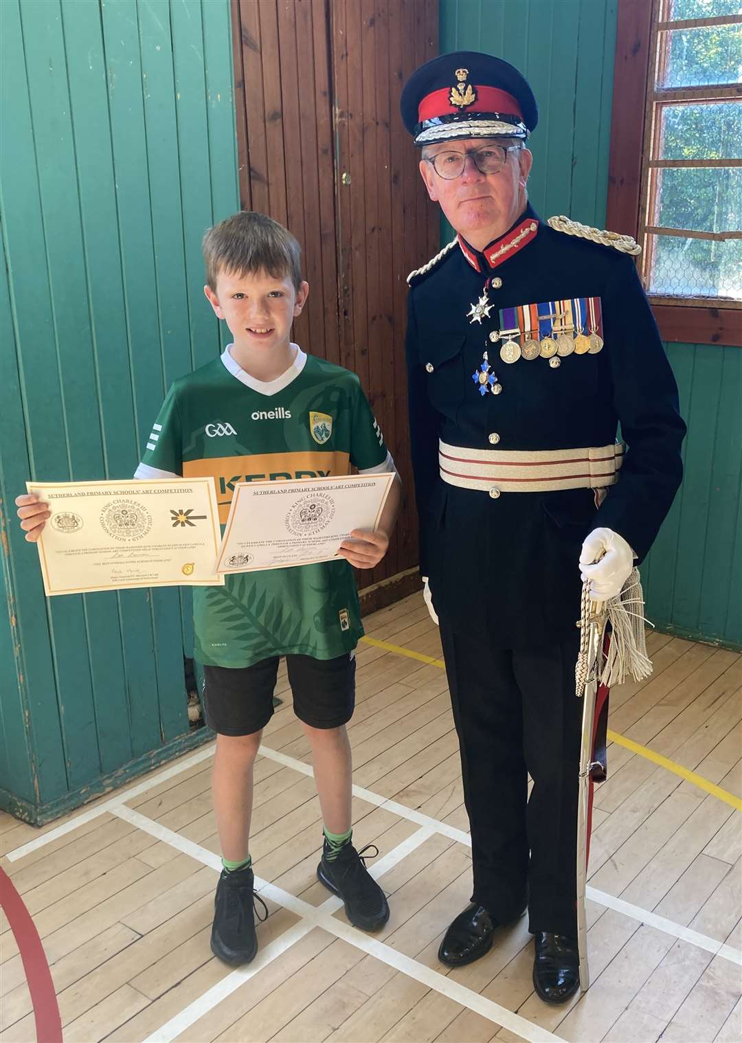 Lord-Lieutenant Patrick Marriott presented Leo Lannon with two certificates, one to mark his overall win and the other his P4-7 class win.