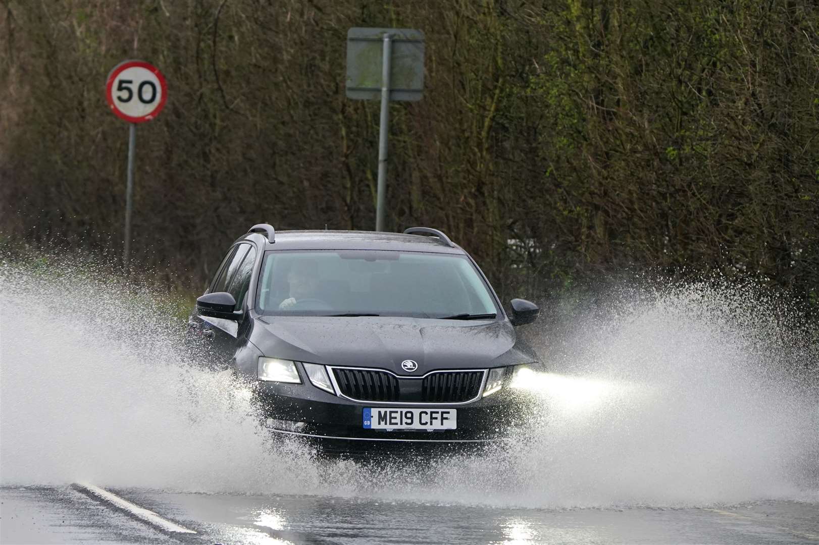 Traffic goes through a flooded road near Folkestone, Kent (Gareth Fuller/PA)