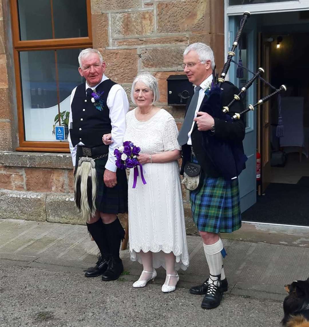 The bride and groom with piper Dr Sandy Gordon.