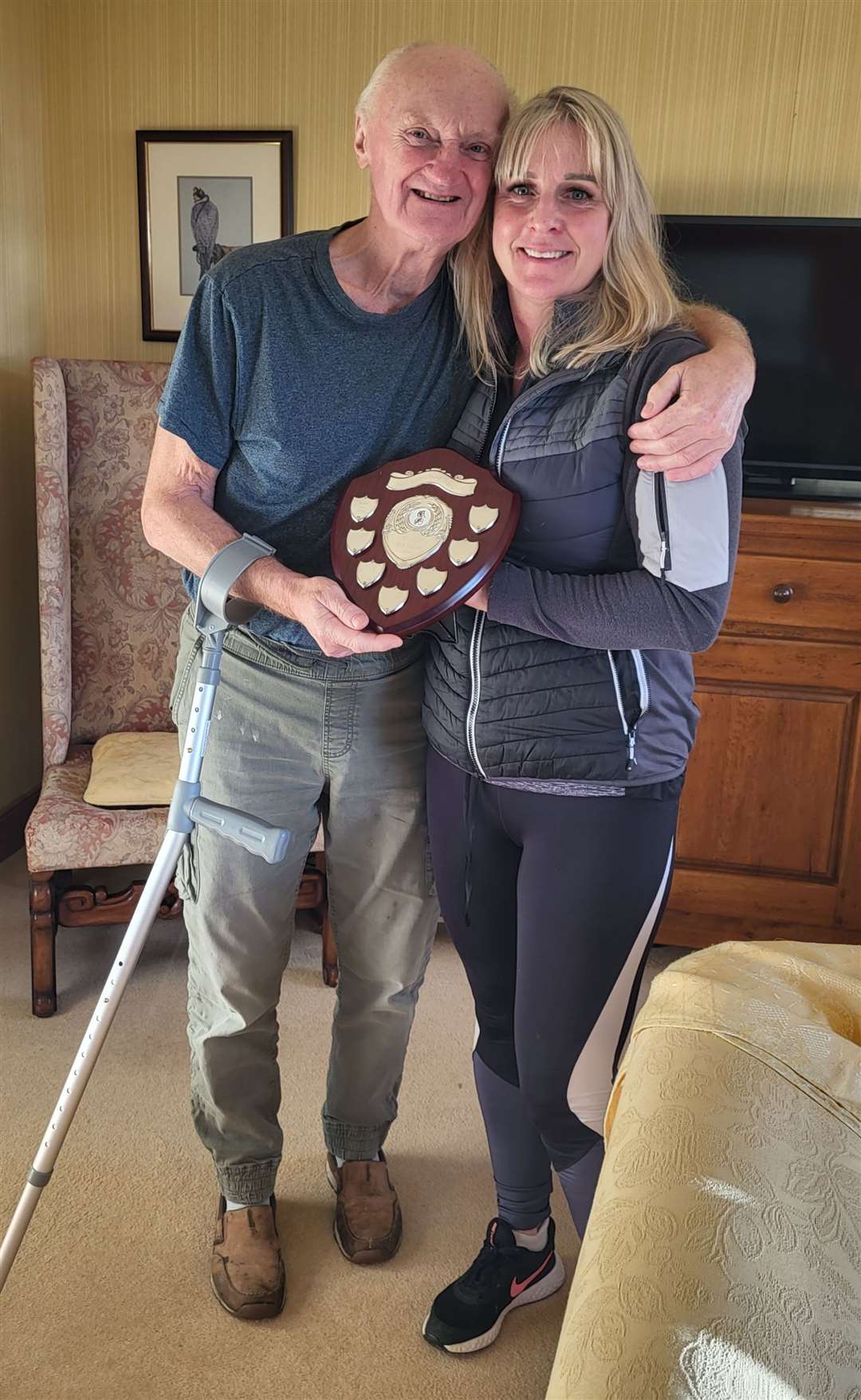 Keith Jones is presented with his e-bike hill climb champion’s trophy by Tracy Murray, the club’s vice-chairperson.