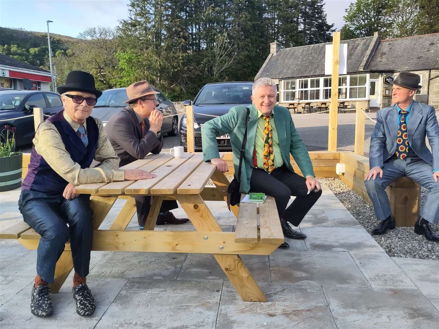 Members of the Budapest Cafe Orchestra relax outside Rogart Mart.