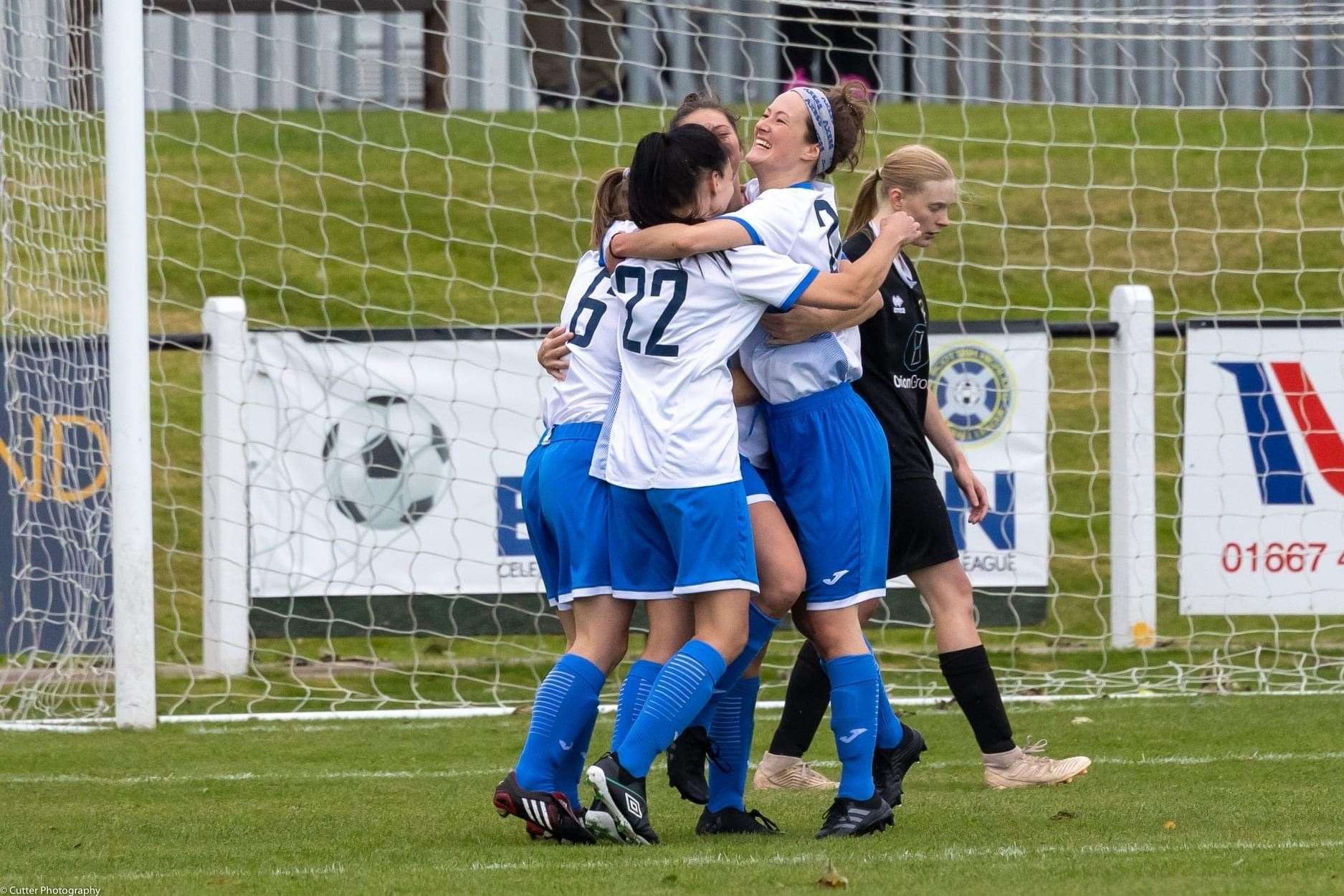 Franci (right) celebrates with her teammates during a Sutherland Women's FC game.