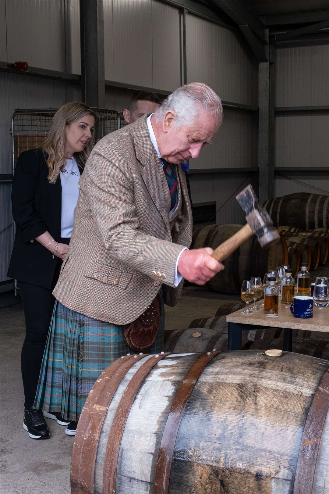 His Majesty hammering in the bung after filling a whisky cask. Picture: Susie Mackenzie