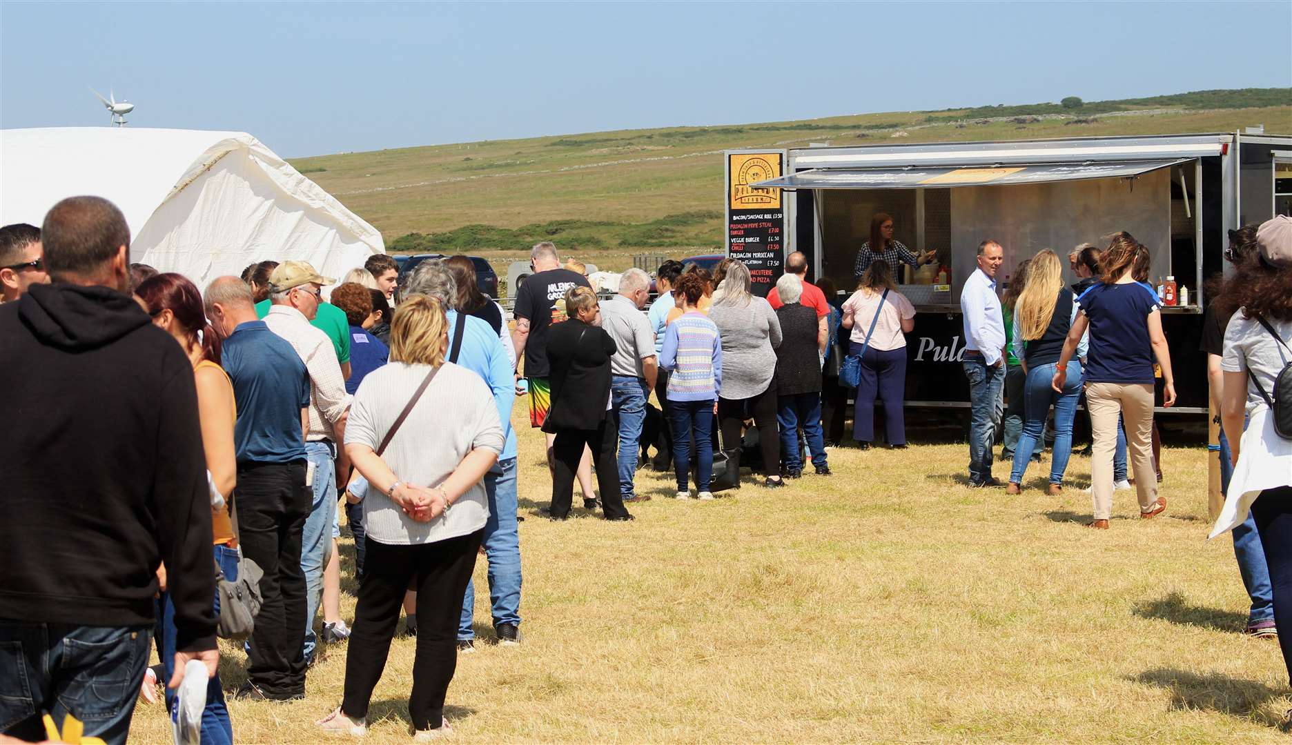 Queuing for snacks from the Puldagon Farm stall. Picture: Alan Hendry