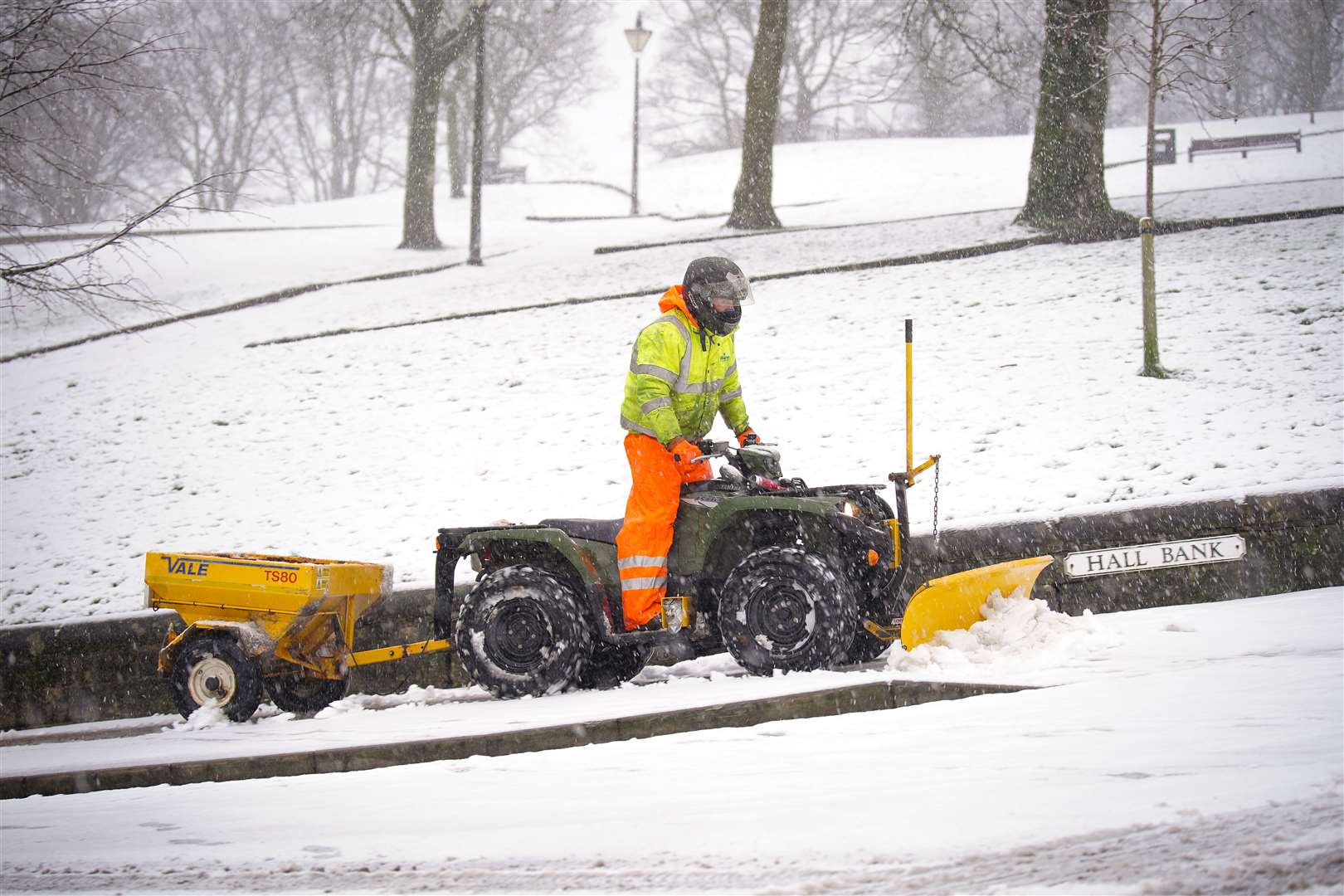 A snowplough clears a path at Hall Bank in Buxton in the Peak District (Peter Byrne/PA)